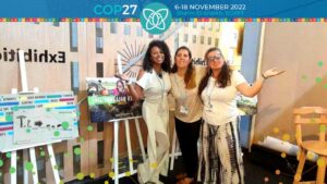 Elisangela, Niveen and Renata standing in the GEN Exhibit at COP27